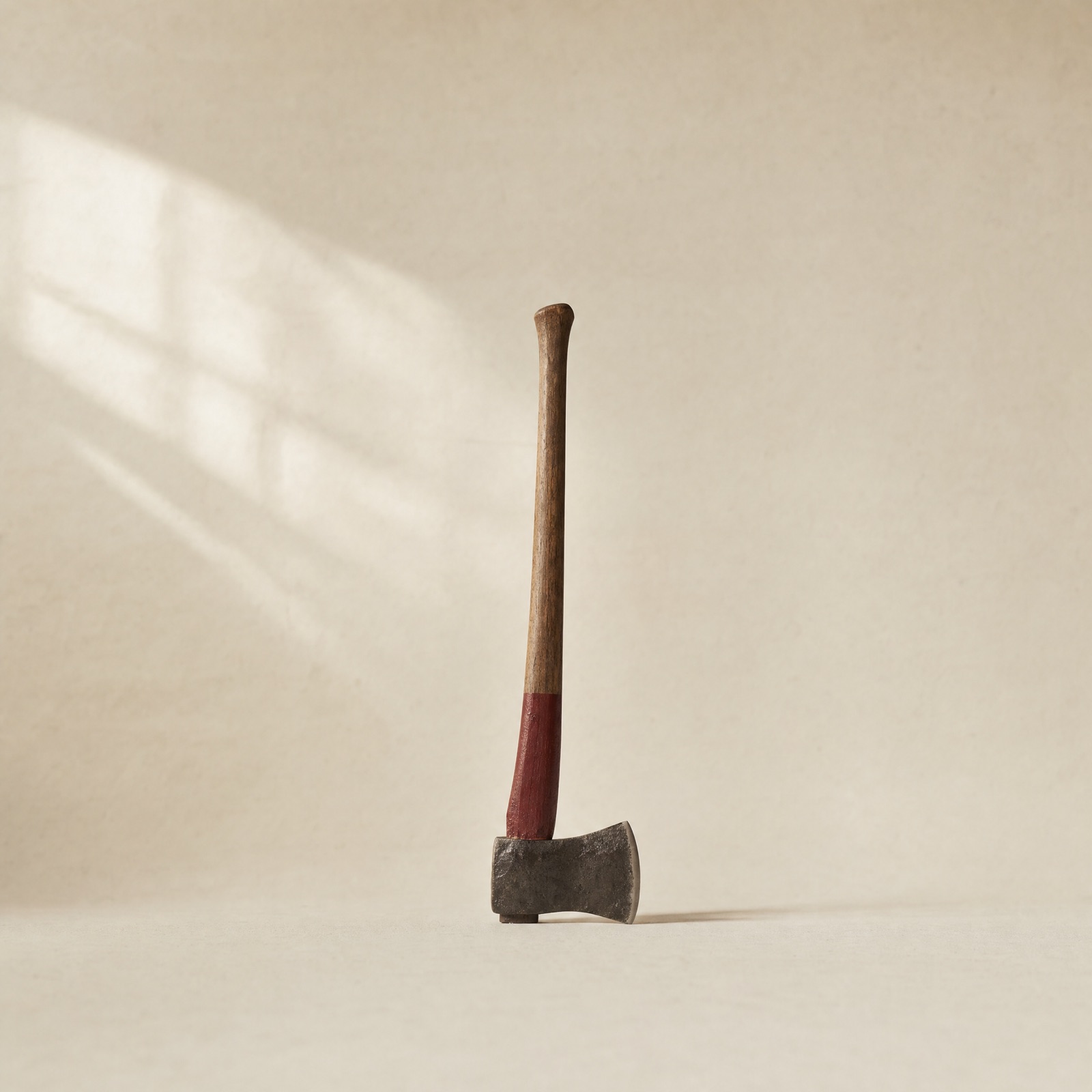 No. 01 Felling Axe — hand-forged steel head on a hickory handle with a burgundy-painted band